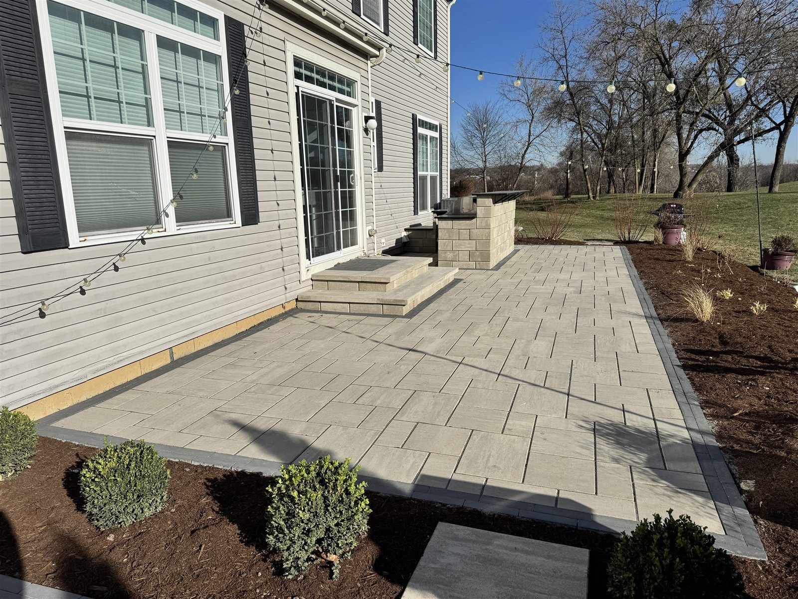 Modern paver patio with charcoal border